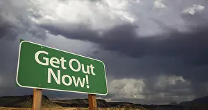 Desolate Street Scene Photo Drucke: Get out green road sign with dramatic clouds and rain