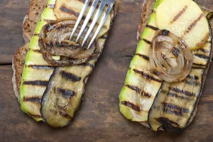 Vegetable Starters Drucke: Grilled vegetables on rustic bread over wood table