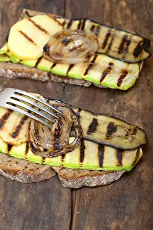 Vegetable Starters Drucke: Grilled vegetables on rustic bread over wood table