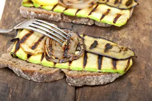 Vegetable Starters Drucke: Grilled vegetables on rustic bread over wood table