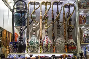 Oriental Water Pipes Drucke: Group of eastern hookahs placed of various colors on a shelf