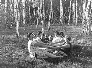 Man And Woman Sitting Together Drucke: Group in the forest holding hands
