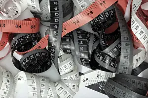 Conceptual Symbol Image Drucke: Group of tangled measuring tapes