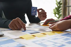 Modern Office Workspace Drucke: Group of ux developer and ui designer brainstorming about app interface design at modern office