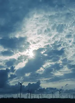 Environmental Protection Germany Drucke: Group of wind turbines in front of a dramatic cloudy sky