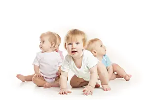 White Background Kids Drucke: Group of witty babies sitting in different clothes