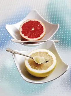 Studio Still Life Photos Drucke: Half of a grapefruit and grapefruit ruby in porcelain bowls