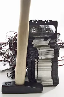 Electronic Music Equipment Drucke: Hammer in front of a stack of floppy disks and an audio tape