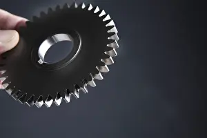 Studio Shot Of Gears Drucke: Hand with gear