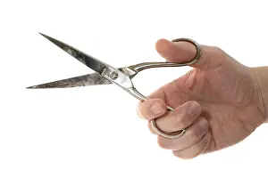 White Background Photography Drucke: Hand holding a scissors isolated on white background