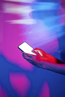 Modern Technology Concept Drucke: A hand interacts with a smartphone