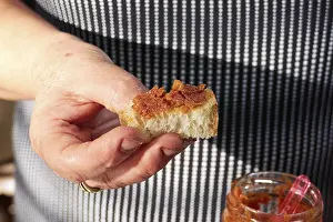 Uninhabited Island Food Scene Drucke: Hand, piece of white bread, red spread