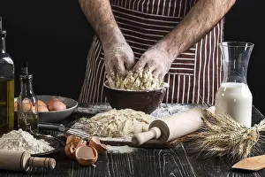 Kitchen Utensil Still Life Drucke: A handful of flour with egg on a rustic kitchen