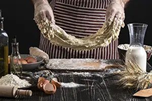 Flour Products Drucke: A handful of flour with egg on a rustic kitchen