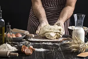 Flour And Egg Mixture Drucke: A handful of flour with egg on a rustic kitchen