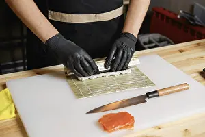 Fresh Fish Ingredients Drucke: Hands of chef making salmon rolls