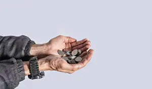 Symbolic Image Of Wealth Drucke: Hands with several coins in isolated background