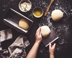 Rustic Food Photography Style Drucke: Hands gently shape dough on a floured surface