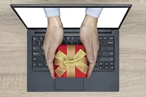 Online Shopping Drucke: Hands with a gift come out from a screen of a laptop computer