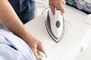 Cleanliness In Architecture Drucke: Hands ironing clothes close up