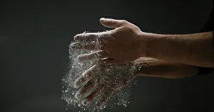 Studio Shot Of Hands Drucke: Hands of Man with Flour against black background