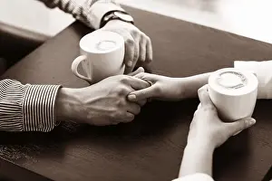 One Person Meal Setup Drucke: Hands on the table holding cups of coffee