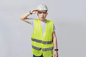 Young Engineer Drucke: Handsome engineer looking into the distance isolated