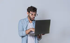 Hispanic Entrepreneur Drucke: Handsome guy checking his laptop isolated