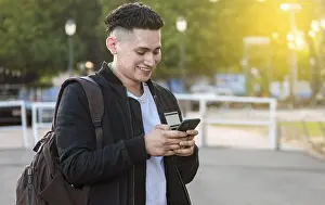 Young Man On Phone Drucke: Handsome guy texting with his phone