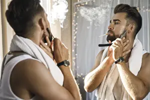Male Portrait Photography Drucke: Handsome man looking in the mirror