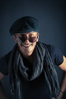 Single Person Pose Drucke: Handsome young man posing with hat