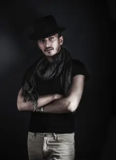 Blue Background Image Drucke: Handsome young man posing with a hat