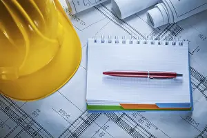 DIY Home Improvement Project Drucke: Hard hat checked notebook pen blueprints on construction drawing