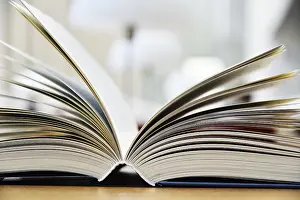 Educational Institution Drucke: Hardcover book lying on the table in a library