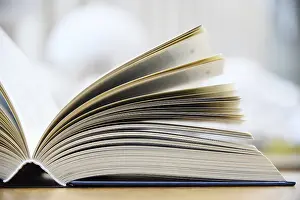 Educational Institution Images Drucke: Hardcover book lying on the table in a library