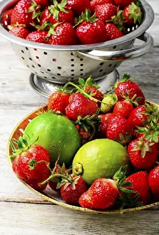 Agricultural Harvest Images Drucke: Harvest rustic strawberry and lime fruit on light background