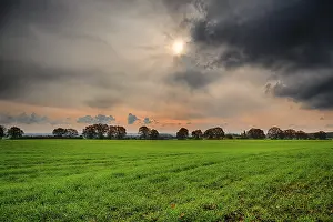 Cloudy Atmosphere Photography Drucke: Hdr shoot of a landscape with thunder clouds an the sun