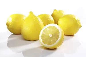 Citrus Fruit Still Life Drucke: Heap of lemons one cut open