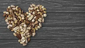 Symbolic Heart Image Drucke: Heart shape form made from nuts copy space