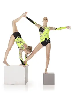 Circus Artist Training Drucke: Two high skill acrobats exercise program on cube isolated