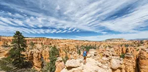 Sandstone Erosion USA Drucke: Hiker with backpack in bizarre landscape