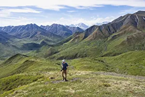 Mountain Chain Of Peaks Drucke: Hiker with camera climbs a mountain