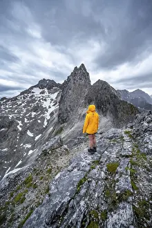 Wetterstein Mountains Drucke: Hiker looking at mountains under dramatic clouds