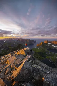 Female Hiker Norway Drucke: Hiker stands at the summit, sunset with dramatic clouds