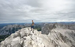 Karwendel Mountain Range Austria Drucke: Hiker at the summit of the Birkkarspitze