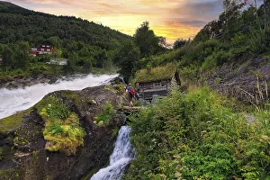 Evening Sky Landscape Drucke: Hikers at Hellesyltfossen waterfall