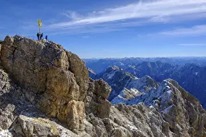 Hiking In Bavaria Germany Drucke: Hikers at the summit with summit cross