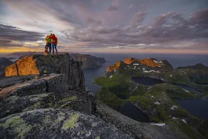 Hiking In Norway Drucke: Two hikers at the summit, sunset with dramatic clouds