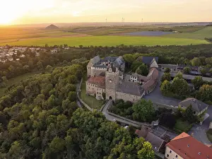 Historic German Castle Drucke: Historic castle surrounded by forests and fields in the evening light