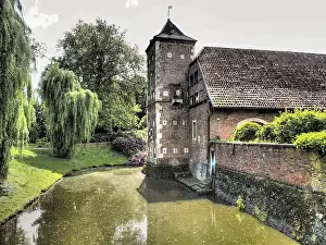 Central Europe Historical Buildings Drucke: Historic tower next to a moat in a green setting surrounded by trees